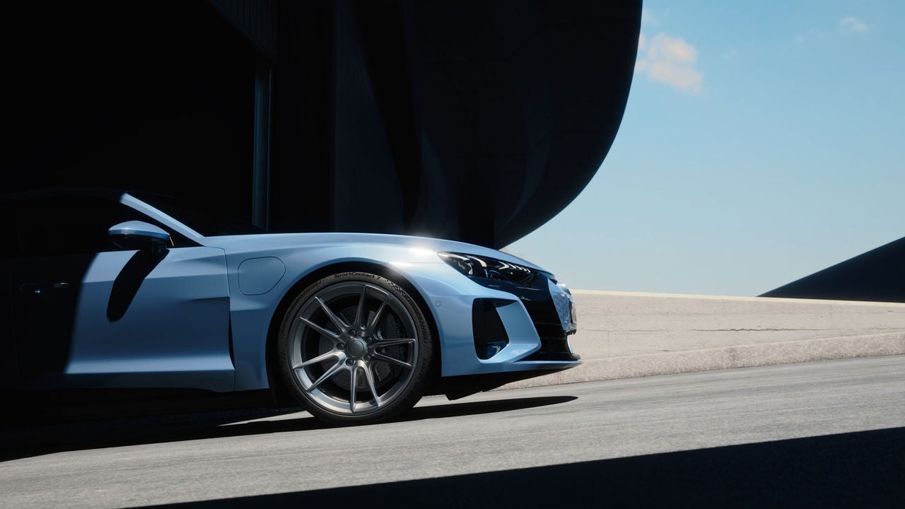 Pneu Continental para Carro, SUV e Veículo Comercial (A imagem apresenta um carro esportivo de cor azul claro, sendo visto de lado, posicionado em um ambiente onde predominam sombras e luz. A parte do carro visível destaca-se com linhas suaves e aerodinâmicas, refletindo um design moderno e elegante. As rodas são de liga leve, com um acabamento prateado que contrasta com a carroceria, estão com pneus de alta performance da Continental, modelo SportContact 7. O fundo mostra uma superfície de concreto clara e uma estrutura escura parcial, sugerindo um espaço amplo e industrial. O céu ao fundo é claro, complementando a cena com um toque de leveza. A iluminação ressalta os contornos do carro, criando um efeito visual atrativo.)