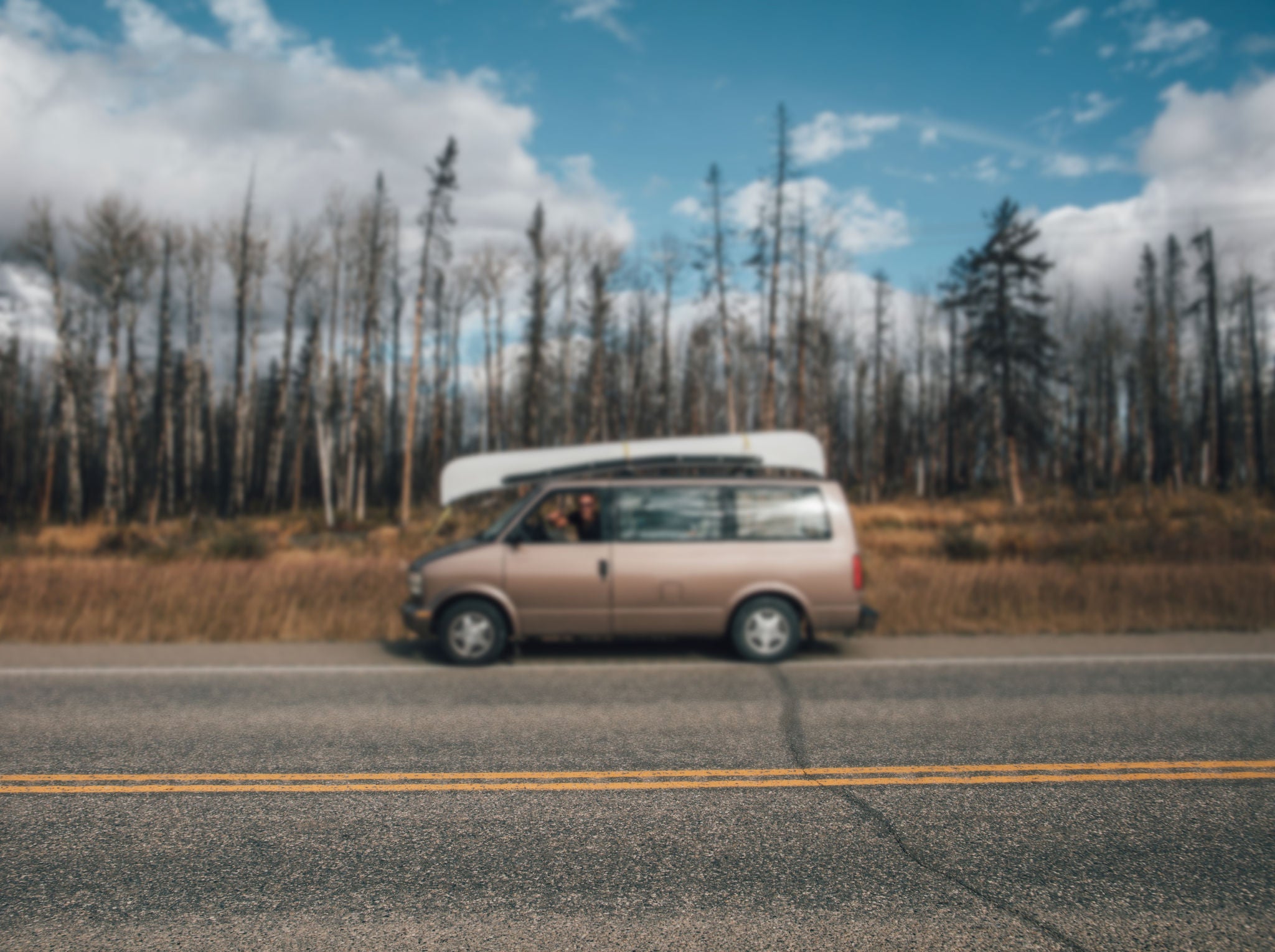 Canada, British Columbia, man with minivan on Alaska Highway